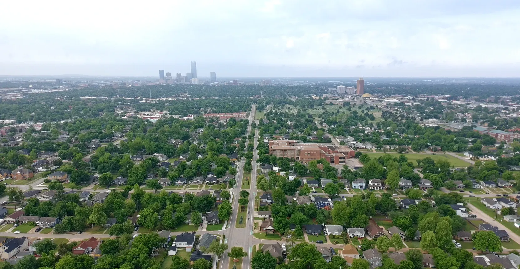 Aerial view of Oklahoma City with the downtown skyline and Gold Dome in the distance